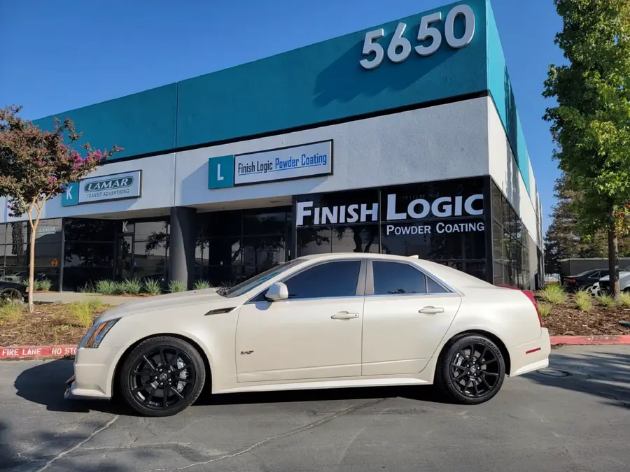 Cadillac CTS-V with OEM wheels powder coated satin black outside the Finish Logic shop